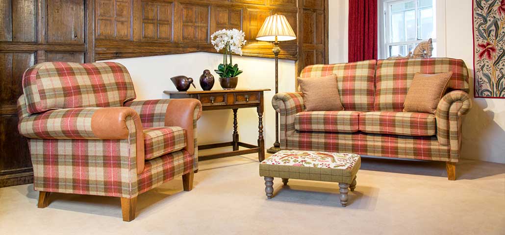 Bedford sofa and chair in red tartan fabric, contrasting leather and scatters, wooden feet, Hines pheasant footstool